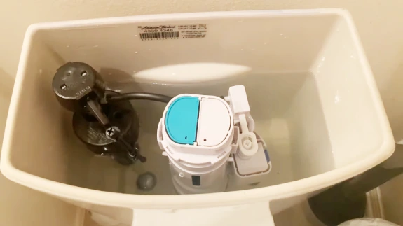 How do you clean a dual flush toilet fill valve